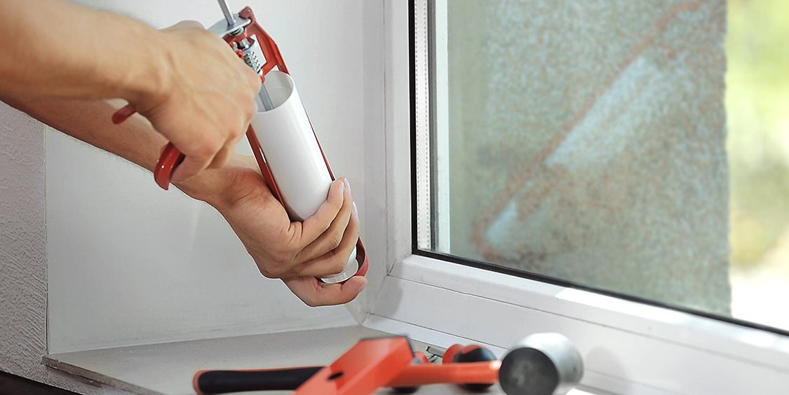 window frame being caulked