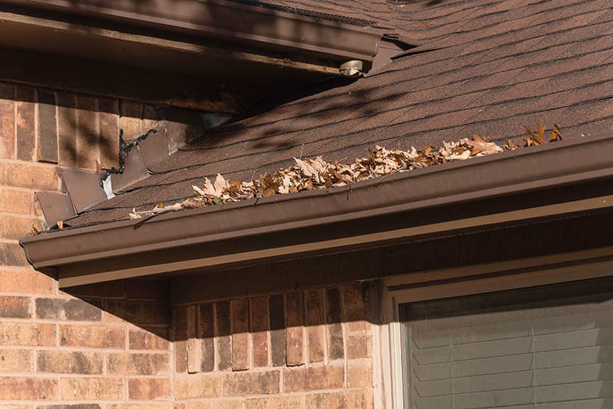 clogged gutters full of leaves.